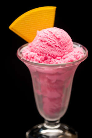 Raspberry ice cream in a tall glassの写真素材