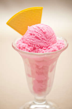 Raspberry ice cream in a tall glassの写真素材