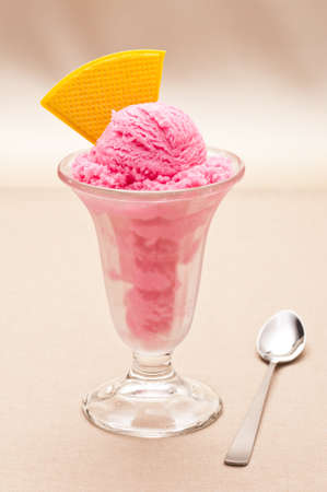 Raspberry ice cream in a tall glassの写真素材