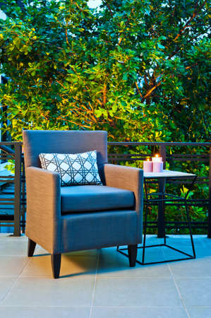 Outdoor patio seating with single chair in the eveningの写真素材