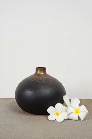 Empty vases decorated with Frangipani flower over side boardの写真素材
