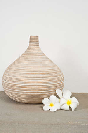 Empty vases decorated with Frangipani flower over side boardの写真素材