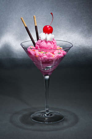 Raspberry ice cream in a Martini glass with with decorationの写真素材