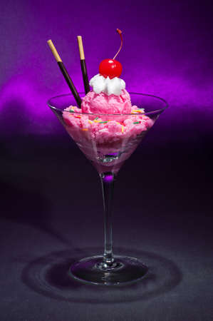 Raspberry ice cream in a Martini glass with with decorationの写真素材