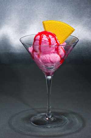 Raspberry ice cream in a Martini glass with with decorationの写真素材