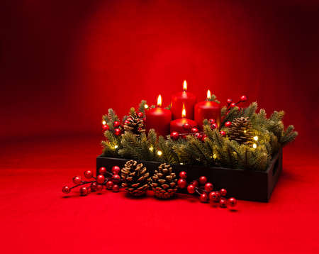 4th Advent red candle Christmas flower arrangement with berriesの写真素材