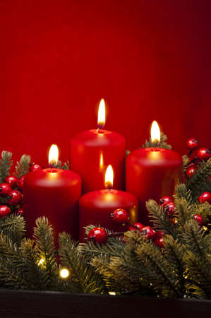 4th Advent red candle Christmas flower arrangement with berriesの写真素材