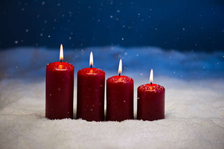 4th Advent candle in snow and snowfallの写真素材