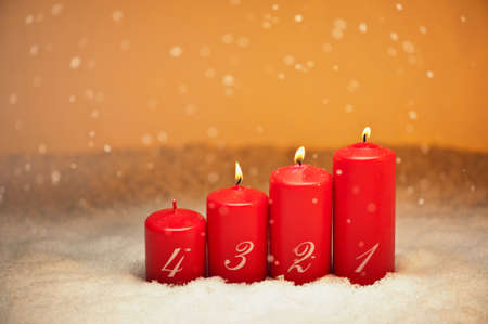3rd Advent candles in snow and snowfallの写真素材