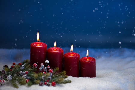 4th Advent candle in snow and snowfallの写真素材