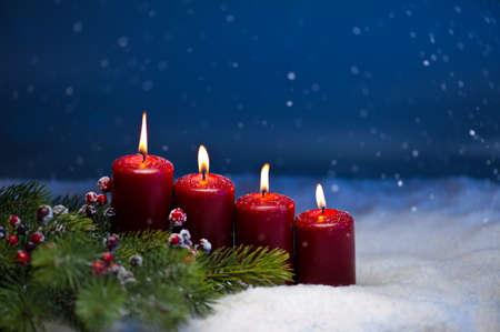 4th Advent candle in snow and snowfallの写真素材