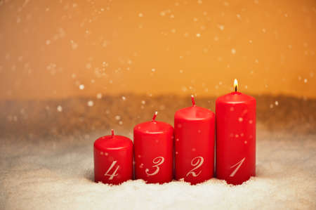 1st Advent candles in snow and snowfallの写真素材