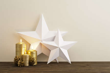 Two stars with three gold candles as Christmas decoの写真素材