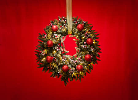 Advent wreath over red background with gold ribbonの写真素材