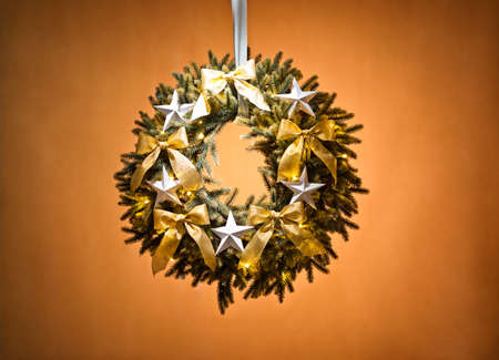 Advent wreath over beige background with gold ribbon and starsの写真素材