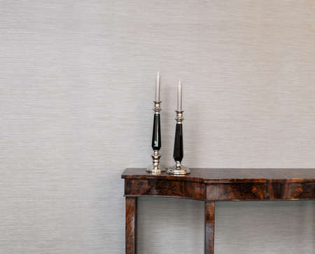 Sideboard in front of a grey wall with candle stickの写真素材