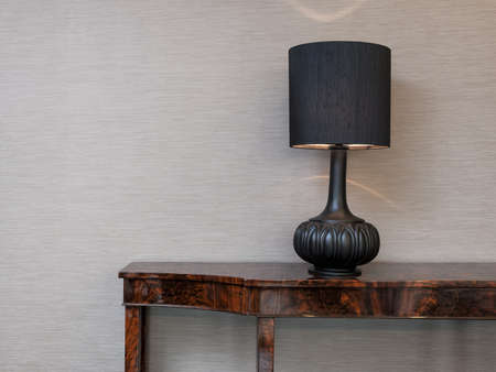 Sideboard in front of a grey wall with table lampの写真素材