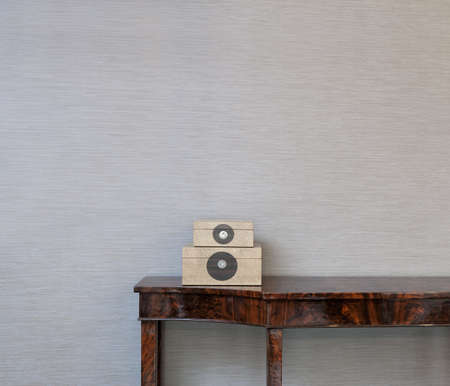 Sideboard in front of a grey wallpaper with art objectsの写真素材