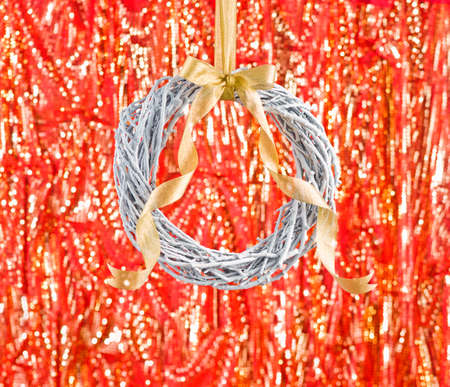 White advents wreath with golden ribbon in front of a fiery backgroundの写真素材