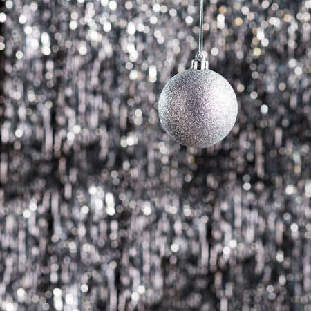 Christmas tree ornament over silver glitter backgroundの写真素材