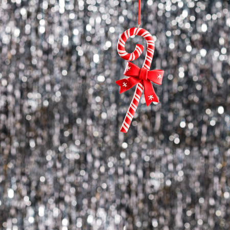 Candy christmas ornament over silver glitter backgroundの写真素材
