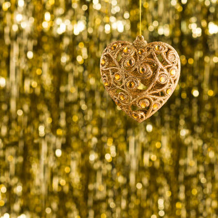 Christmas tree ornament over gold glitter backgroundの写真素材