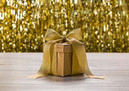 Gold present in front of golden backgroundの写真素材