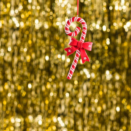 Candy christmas ornament over gold glitter backgroundの写真素材