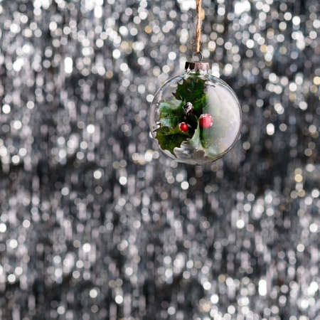 Christmas bauble over silver glitter backgroundの写真素材