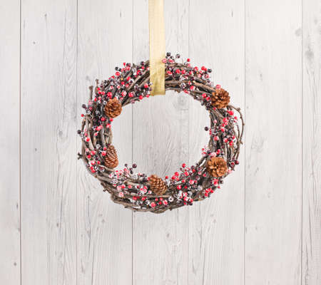 Advents wreath with autumn decoration over a white wooden backgroundの写真素材