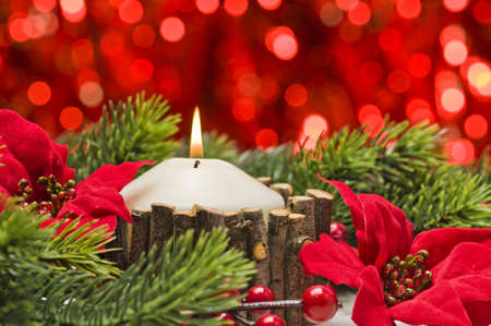 White candles in autumn winter decoration with real branch decorationの写真素材
