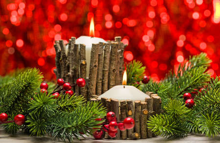 White candles in autumn winter decoration with real branch decorationの写真素材