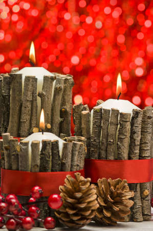White candles in autumn winter decoration with real branch decorationの写真素材