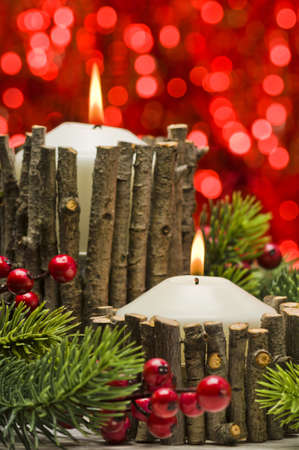 White candles in autumn winter decoration with real branch decorationの写真素材