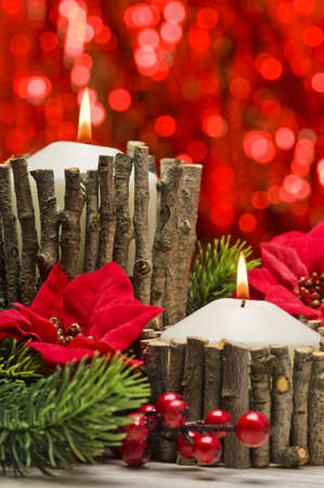 White candles in autumn winter decoration with real branch decorationの写真素材