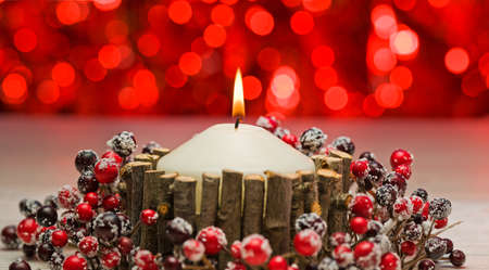 White candles in autumn winter decoration with real branch decorationの写真素材