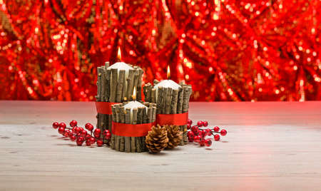 White candles in autumn winter decoration with real branch decorationの写真素材
