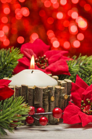 White candles in autumn winter decoration with real branch decorationの写真素材