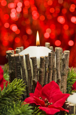 White candles in autumn winter decoration with real branch decorationの写真素材