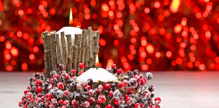 White candles in autumn winter decoration with real branch decorationの写真素材