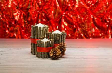 White candles in autumn winter decoration with real branch decorationの写真素材