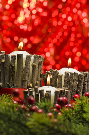 White candles in autumn winter decoration with real branch decorationの写真素材