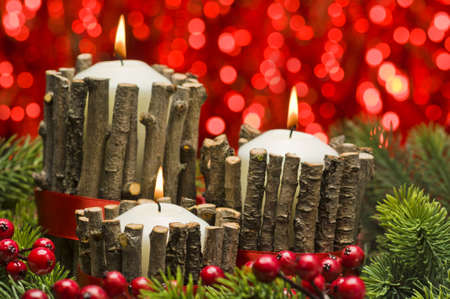 White candles in autumn winter decoration with real branch decorationの写真素材