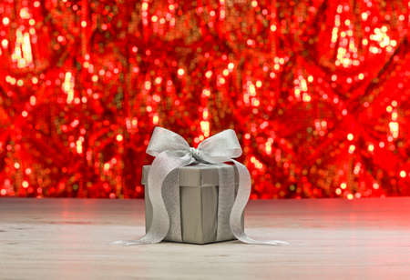 Silver present in front of a sparkling backgroundの写真素材