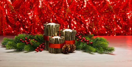 White candles in autumn winter decoration with real branch decorationの写真素材