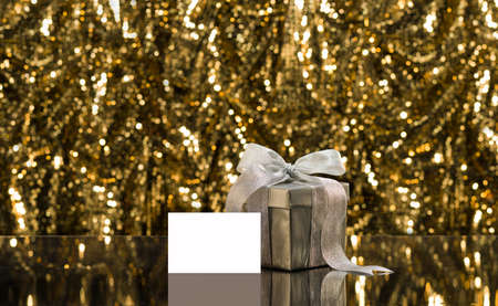 Silver present with place card in front of a sparkling backgroundの写真素材