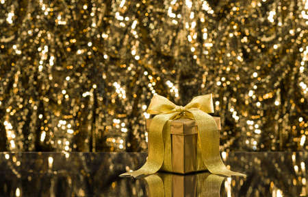Gold present in front of a sparkling backgroundの写真素材