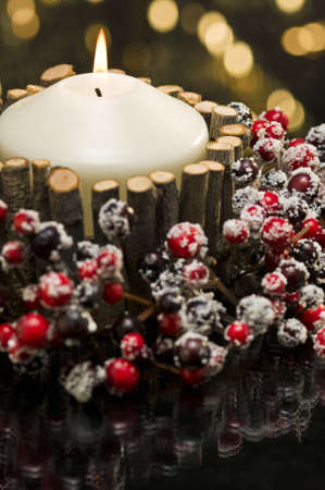 Autumn decorated candle in front of a gold backgroundの写真素材