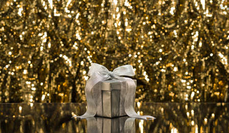 Silver present in front of a sparkling backgroundの写真素材