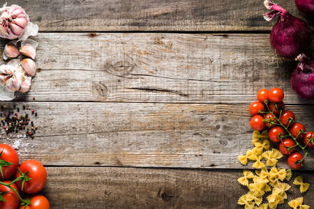 Italian cooking ingredients on a old rustic wooden tableの写真素材